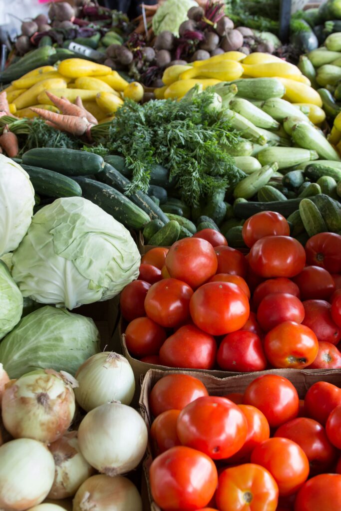 Vibrant display of organic vegetables including tomatoes, cabbages, and more at a North Carolina market.